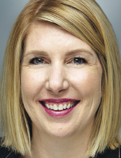 a close up of a woman who is smiling and looking at the camera