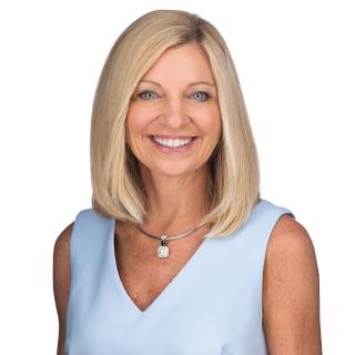 a person wearing a hat and smiling at the camera