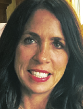 a close up of a woman who is smiling and looking at the camera