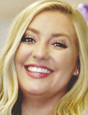 a close up of a woman who is smiling and looking at the camera