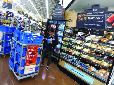 Walmart personal shoppers on the sales floor are picking up to eight different orders at a time to maximize productivity.