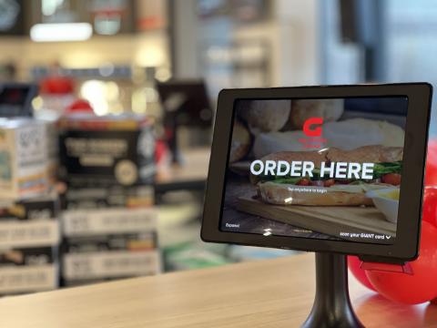 Touchscreen ordering a television is sitting on a table