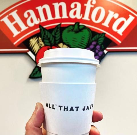 a hand holding a cup of coffee