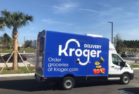 a blue truck parked on the side of a road