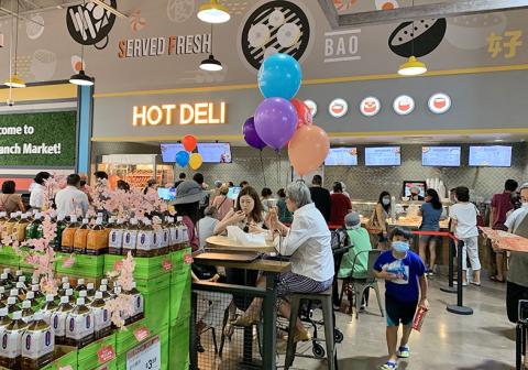 a group of people sitting at a table in front of a store