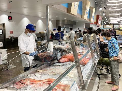 a group of people preparing food in a kitchen