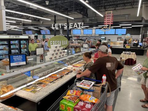 a group of people standing in front of a store
