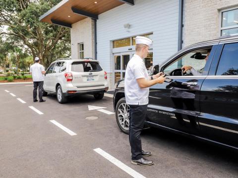 a man standing in front of a car