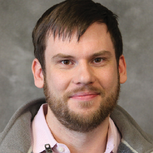 a close up of a man smiling for the camera