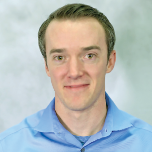 a smiling man in a blue shirt