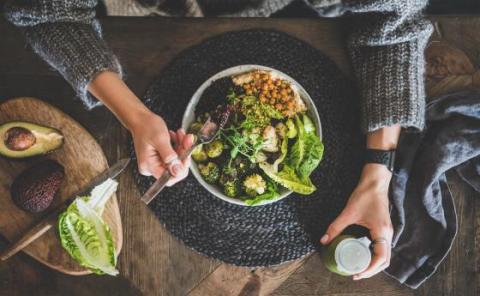 a person holding a bowl of food