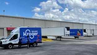 a blue truck parked in front of a building