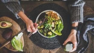 a person holding a bowl of food