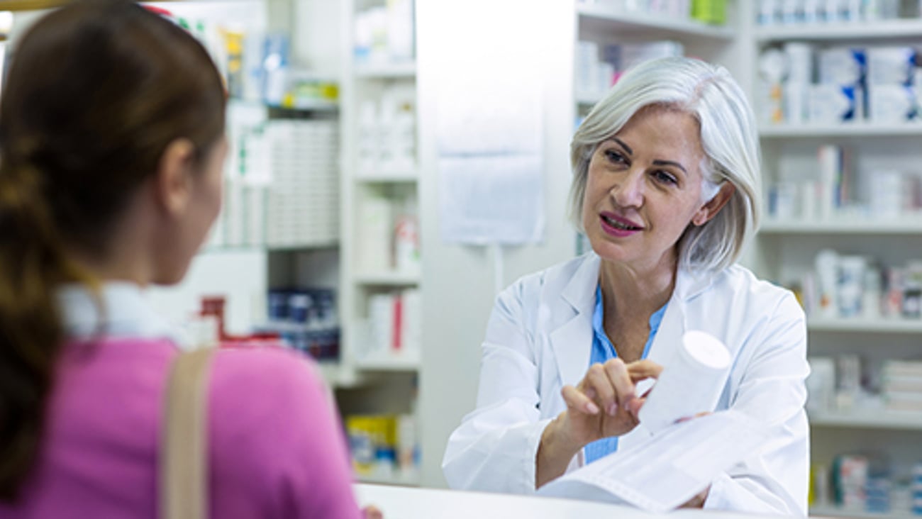 Pharmacist Assisting Patient Teaser