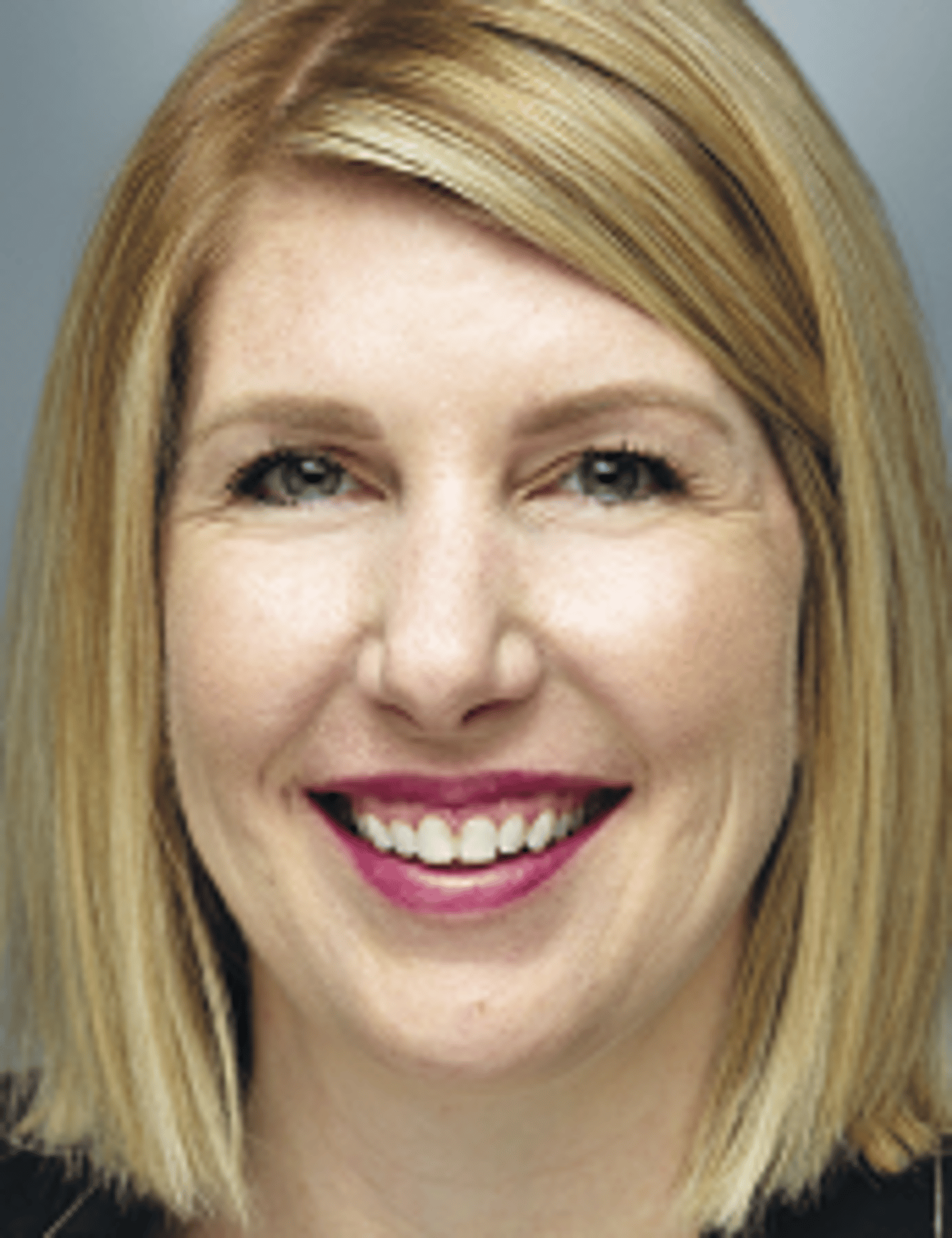 a close up of a woman who is smiling and looking at the camera