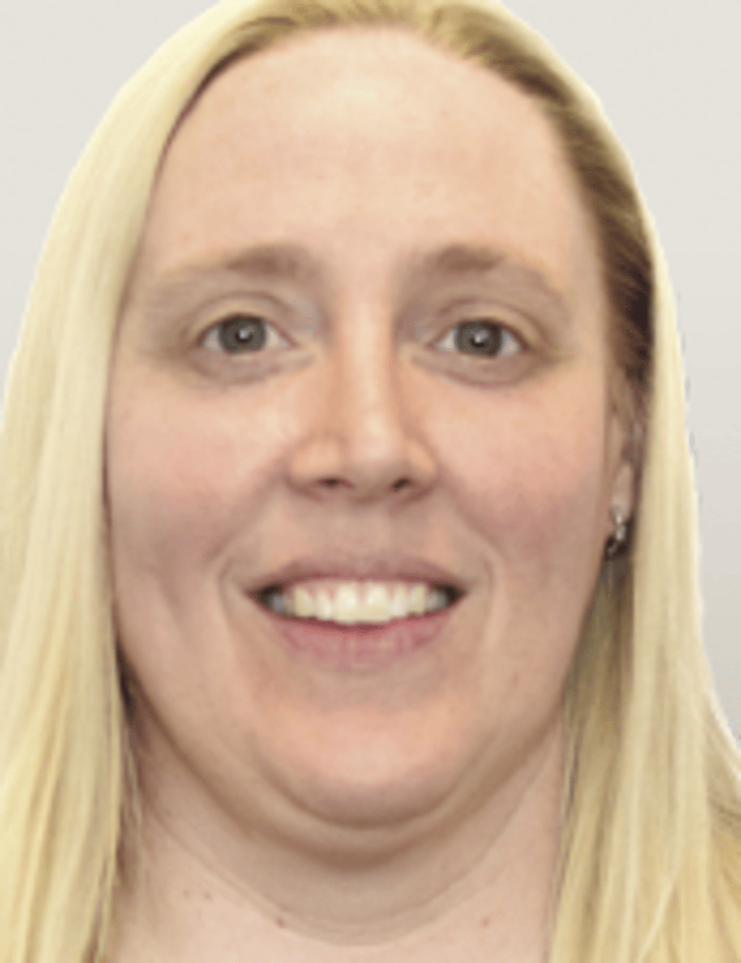 a close up of a woman who is smiling and looking at the camera