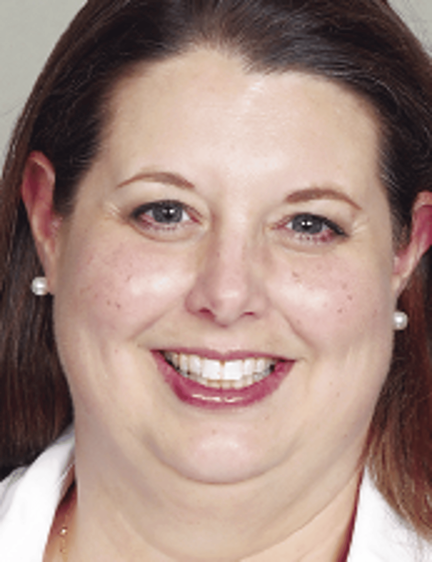 a close up of a woman who is smiling and looking at the camera