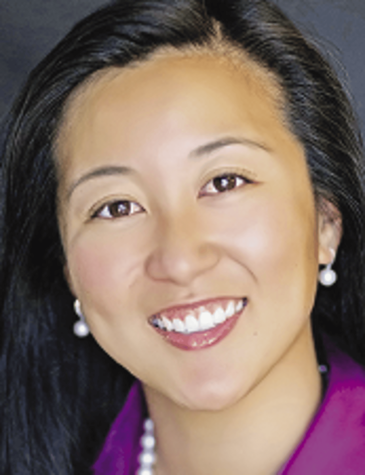 a close up of a woman smiling for the camera