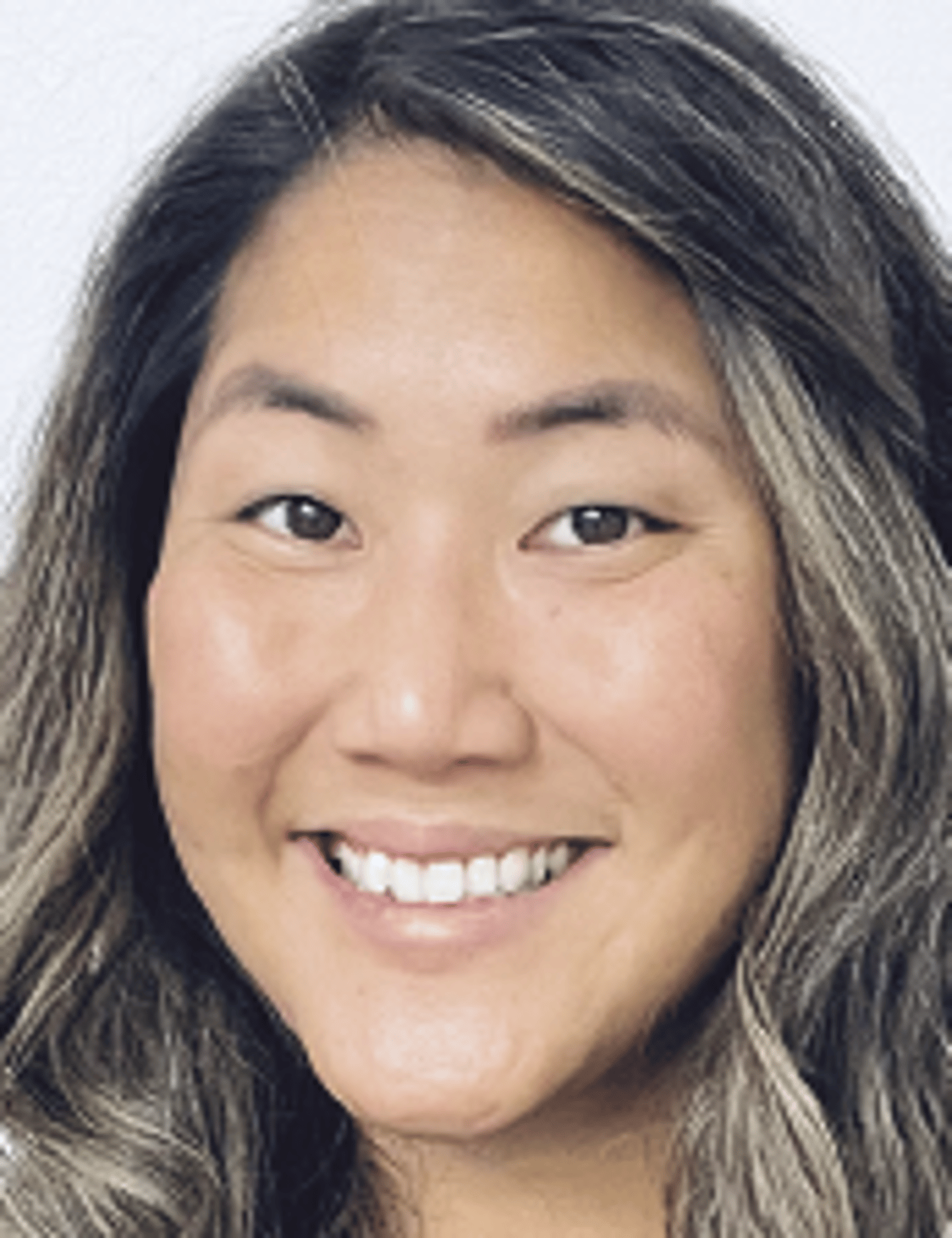 a close up of a woman who is smiling at the camera