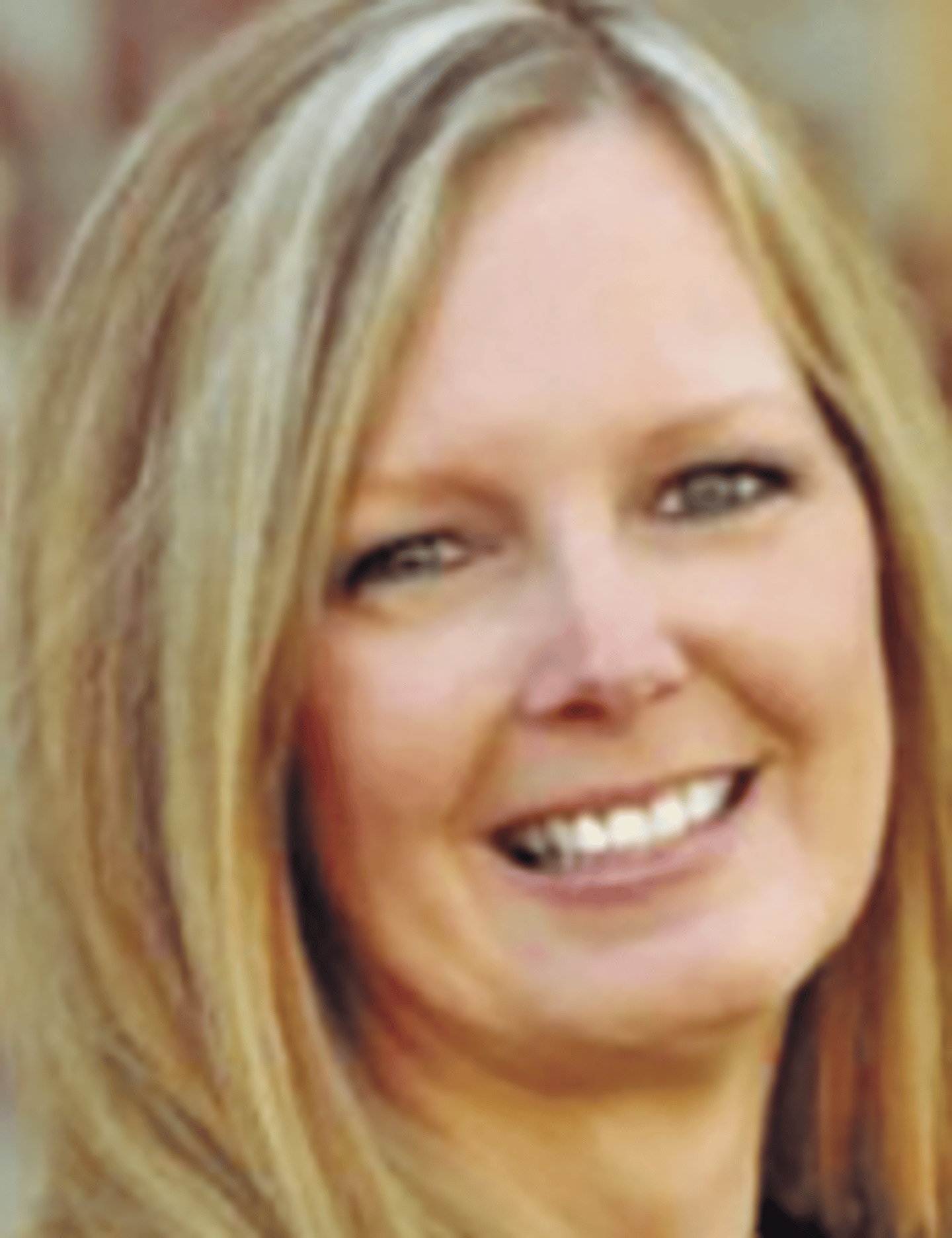 a close up of a woman who is smiling at the camera