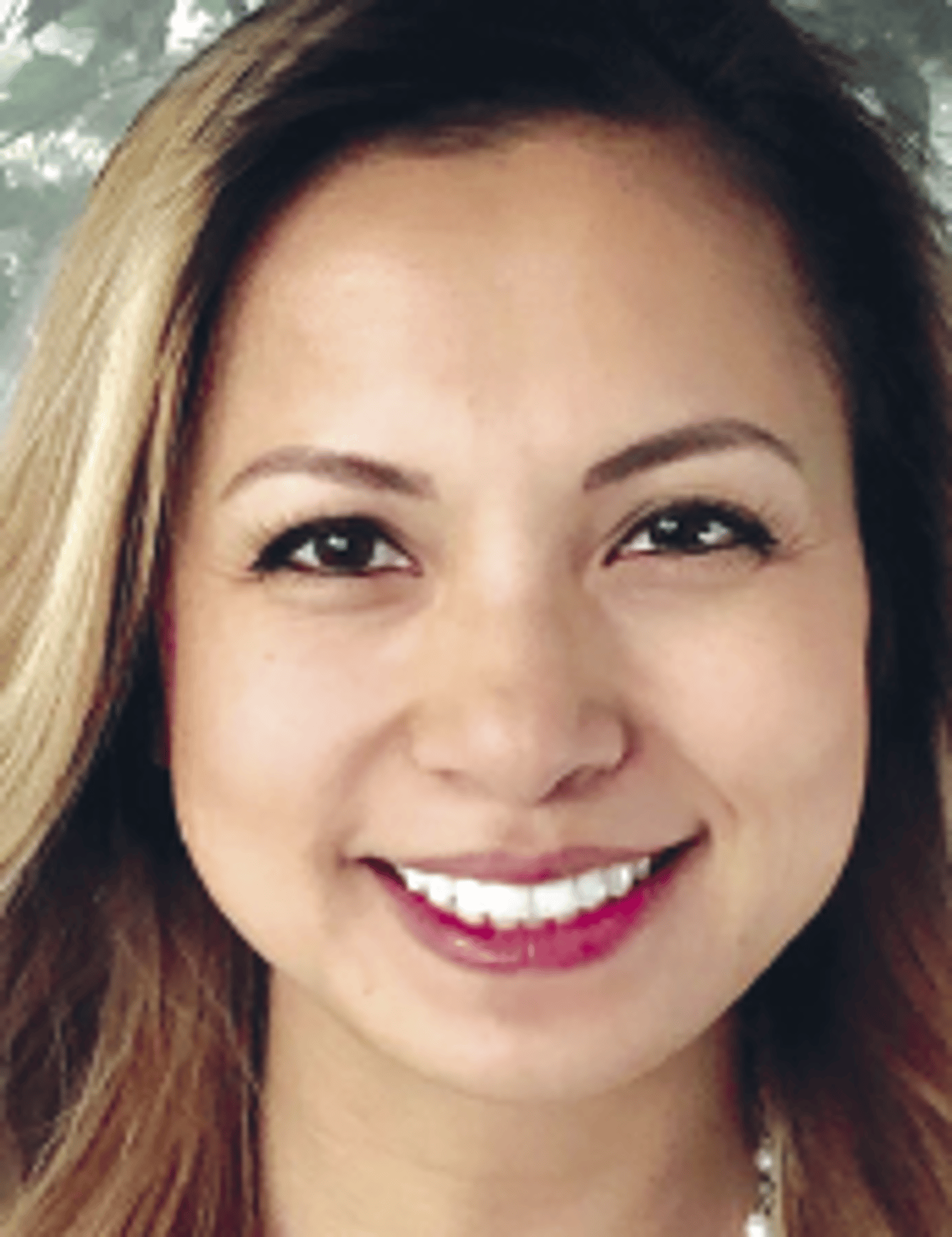 a close up of a woman smiling for the camera