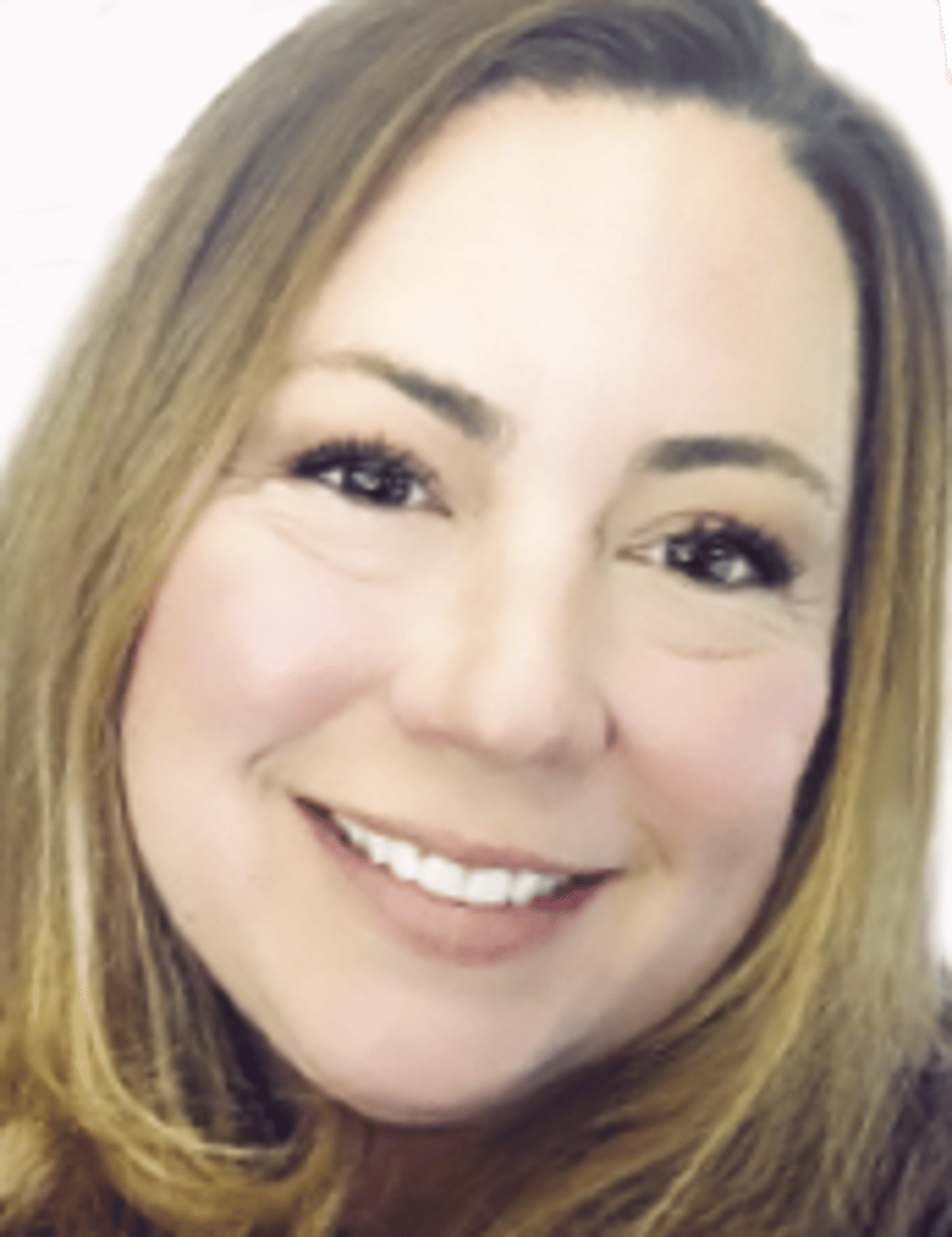 a close up of a woman who is smiling at the camera