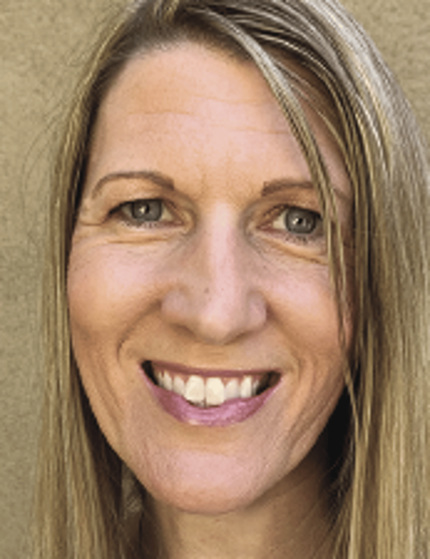 a close up of a woman who is smiling at the camera