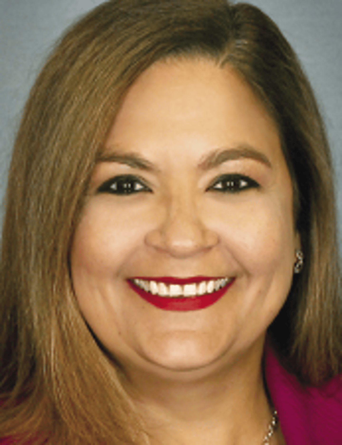 a close up of a woman who is smiling and looking at the camera