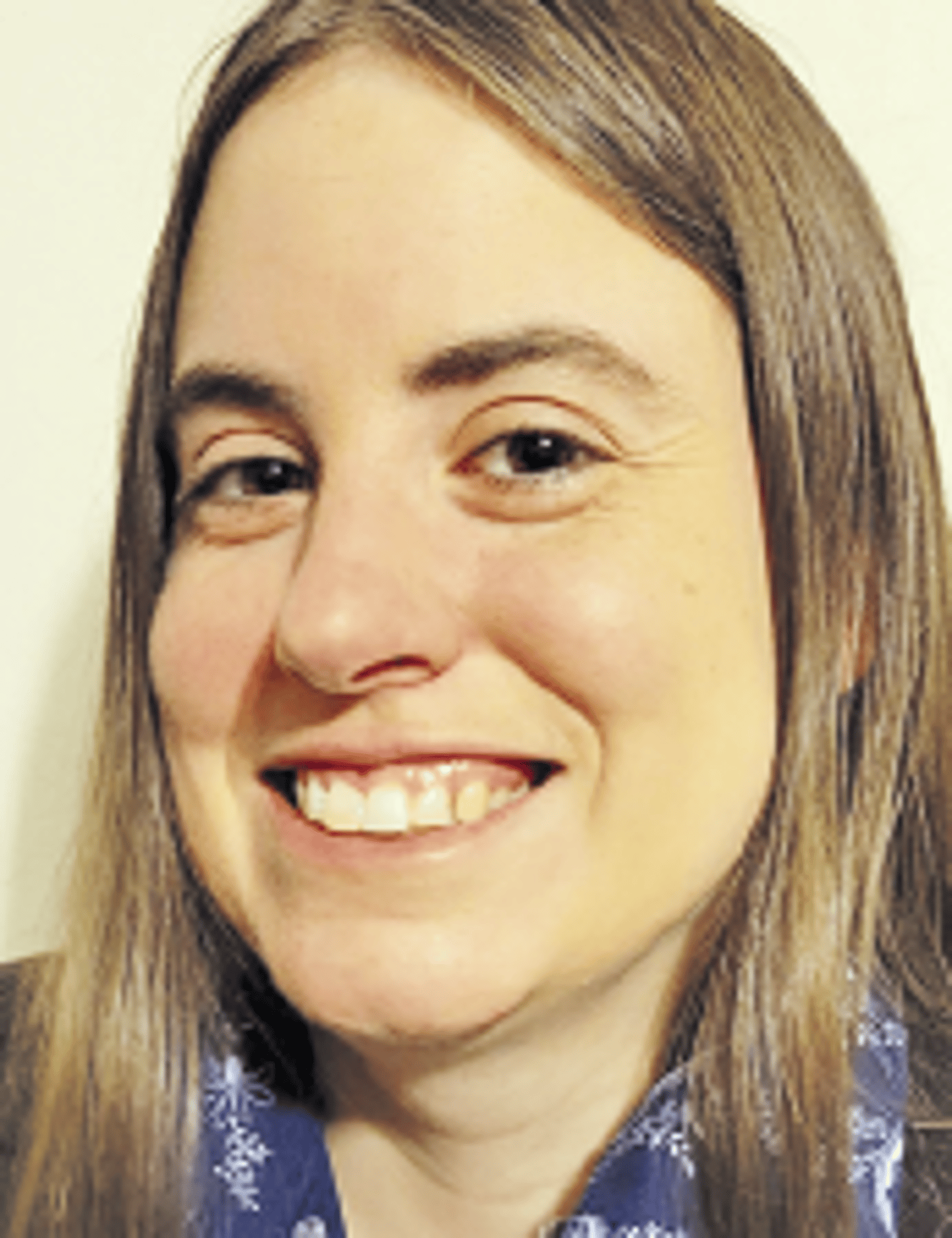 a close up of a woman who is smiling at the camera