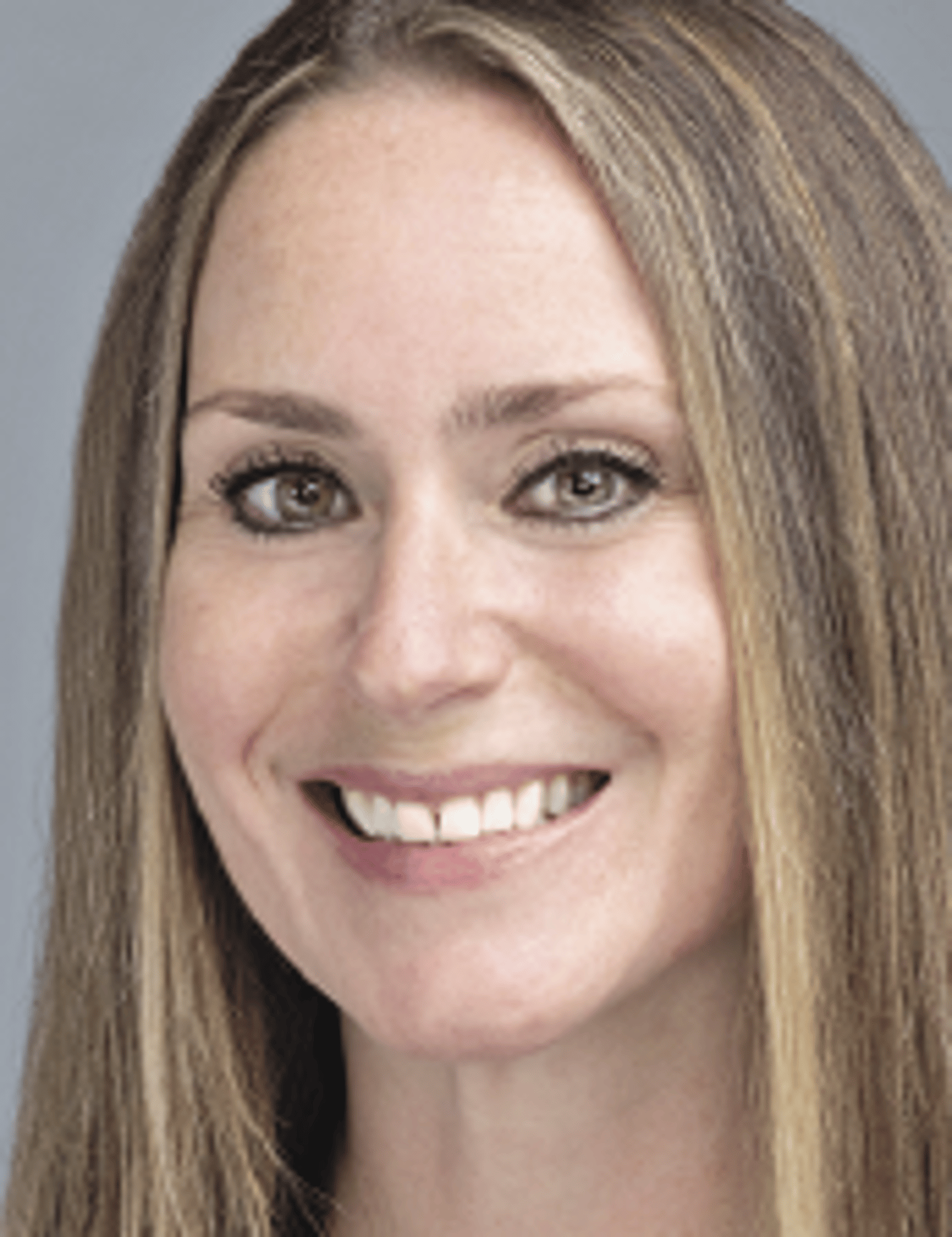 a close up of a woman who is smiling and looking at the camera