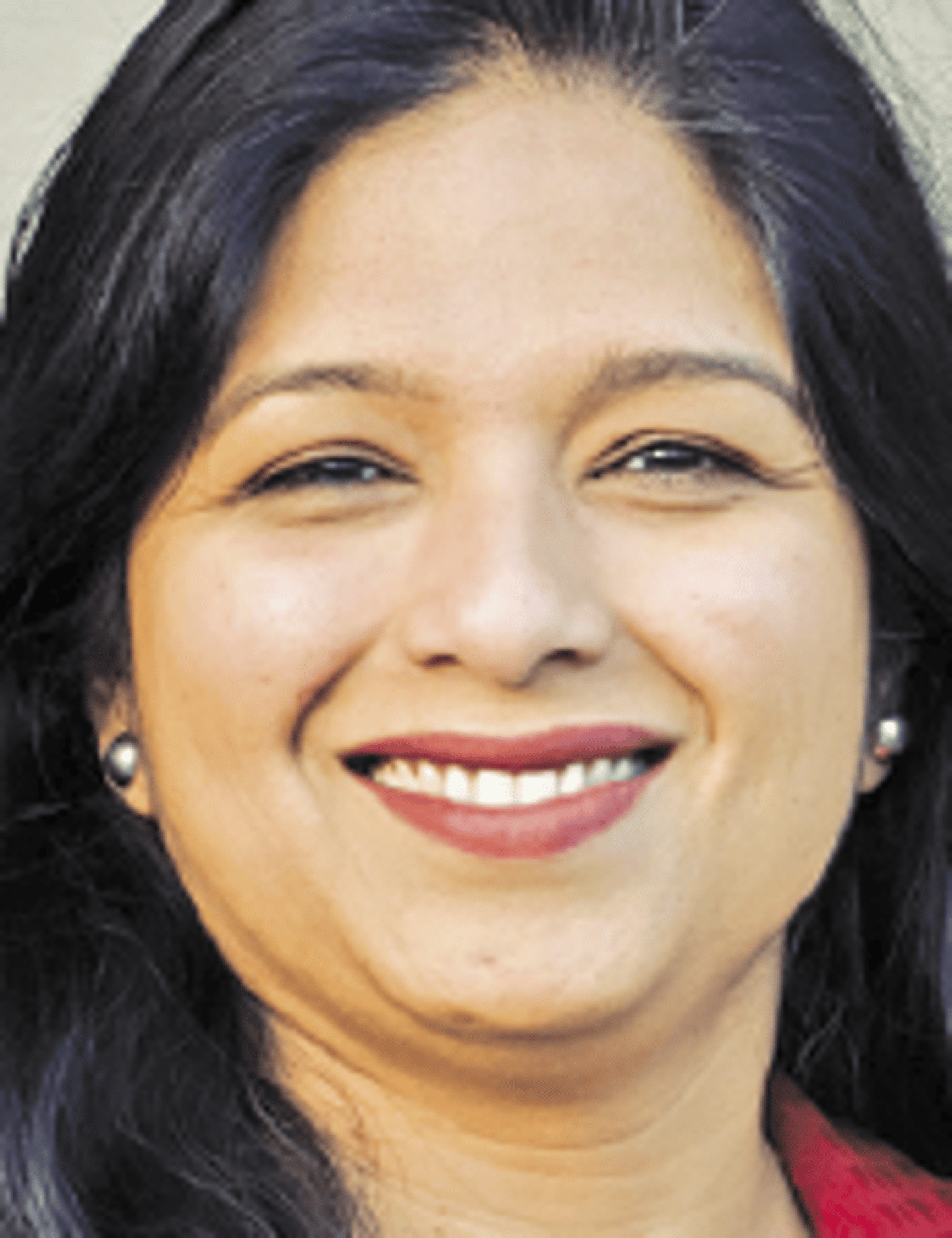 a close up of a woman who is smiling and looking at the camera