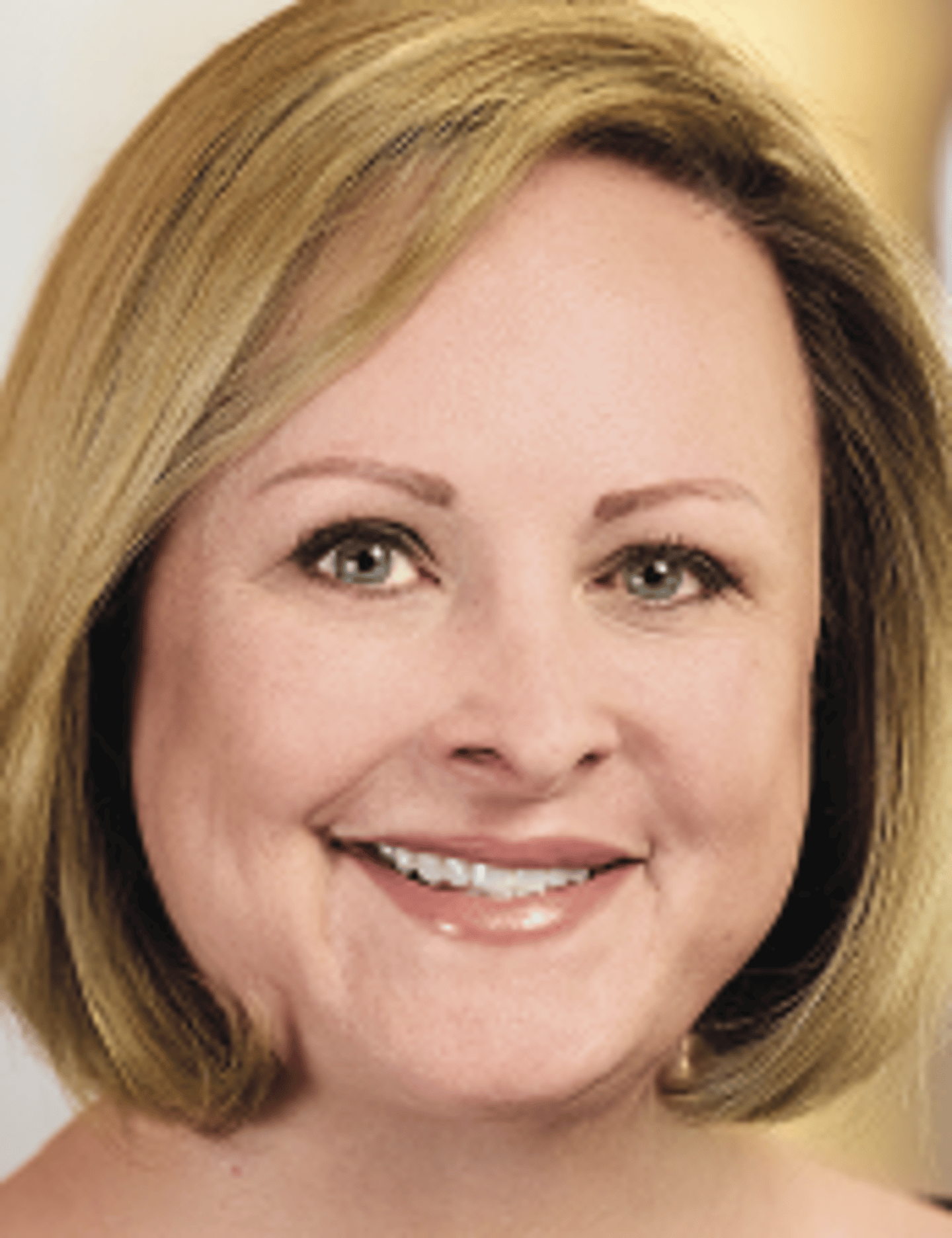 a close up of a woman who is smiling at the camera