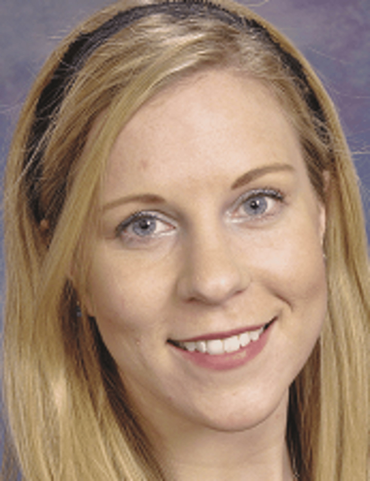 a close up of a woman who is smiling at the camera