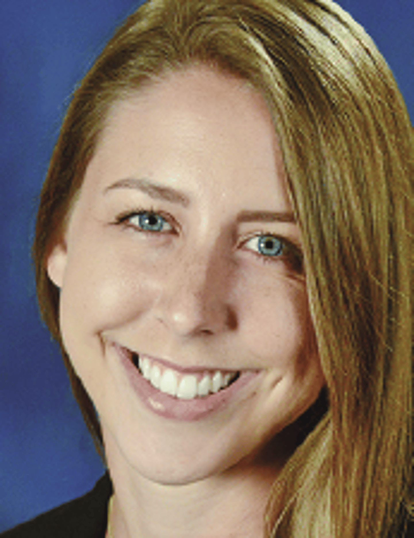 a close up of a woman who is smiling and looking at the camera