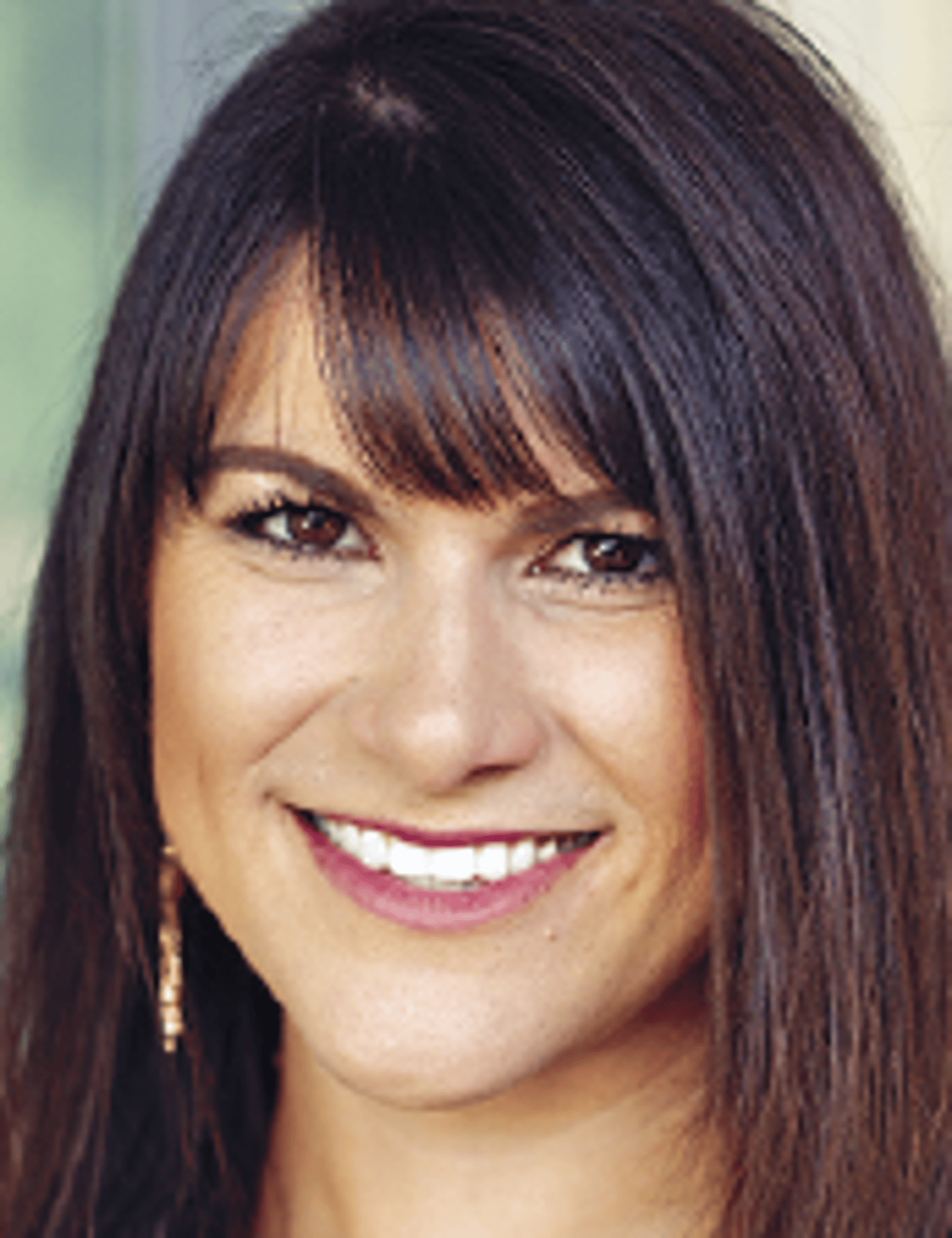 a close up of a woman who is smiling at the camera