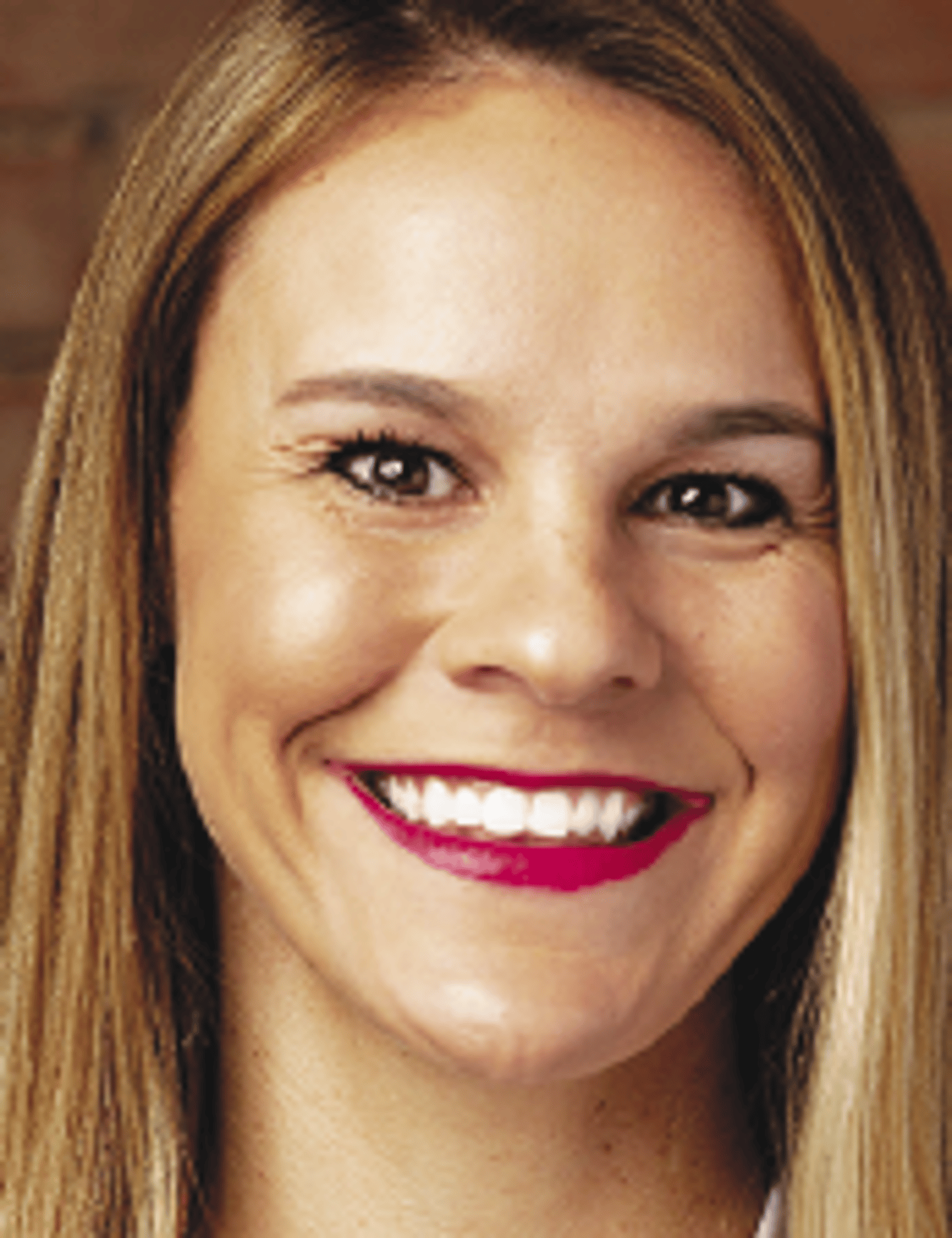 a close up of a woman who is smiling and looking at the camera