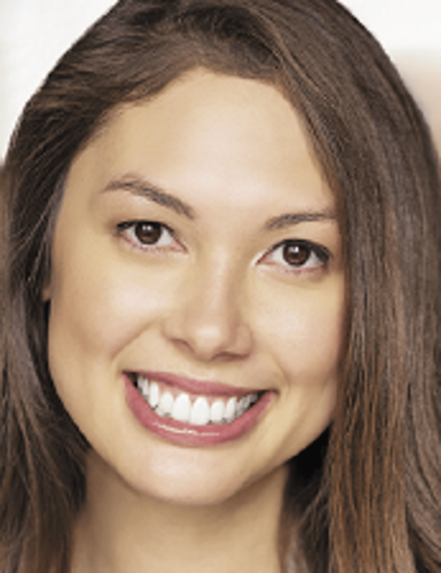 a close up of a girl smiling for the camera