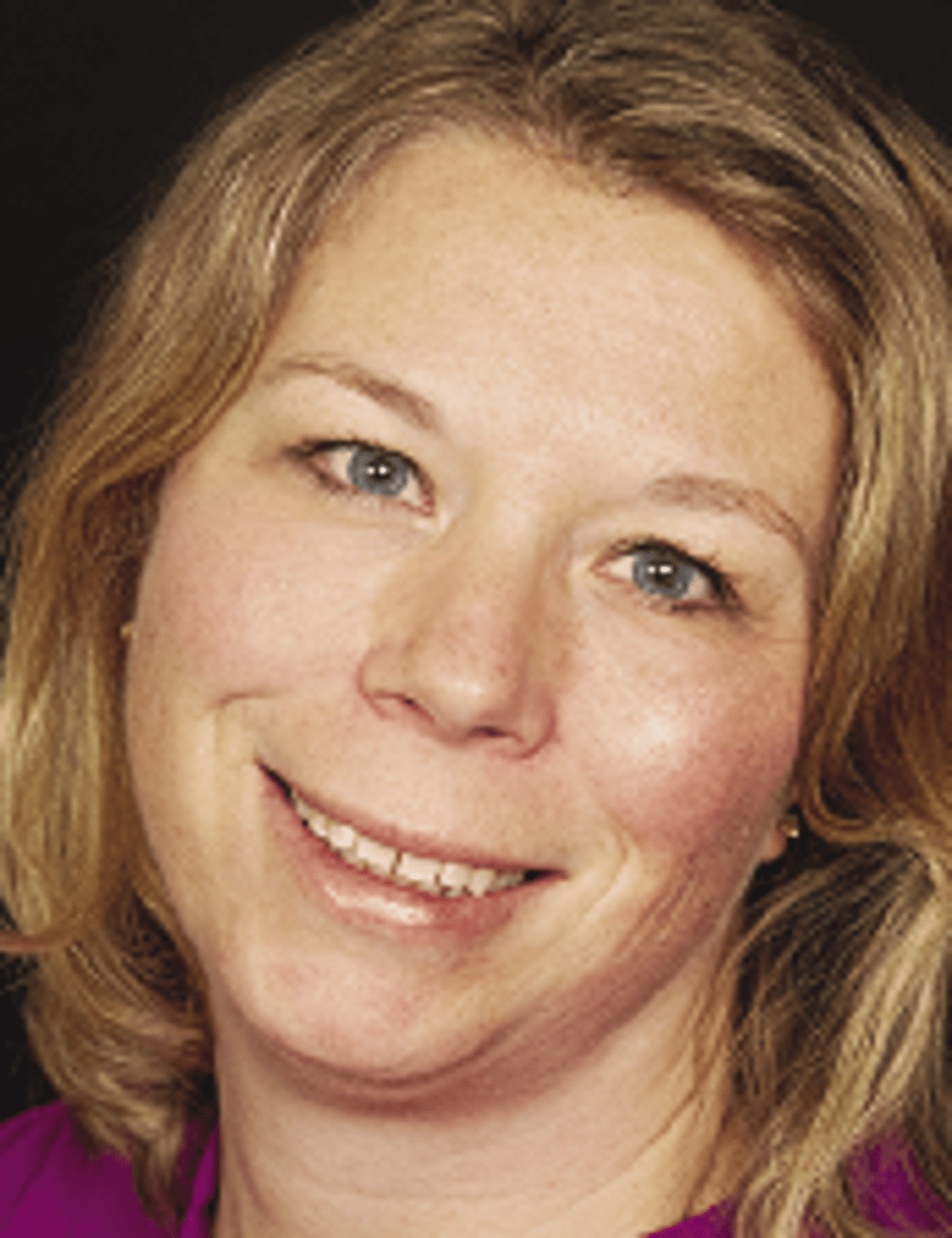 a close up of a woman who is smiling at the camera