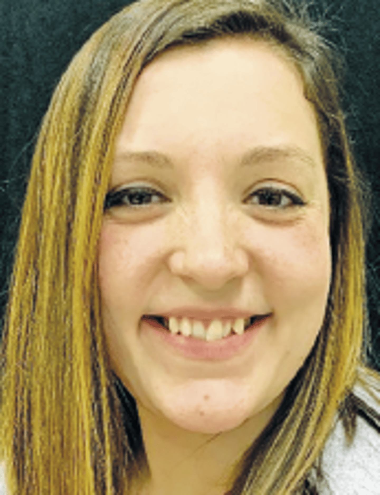 a close up of a woman who is smiling at the camera