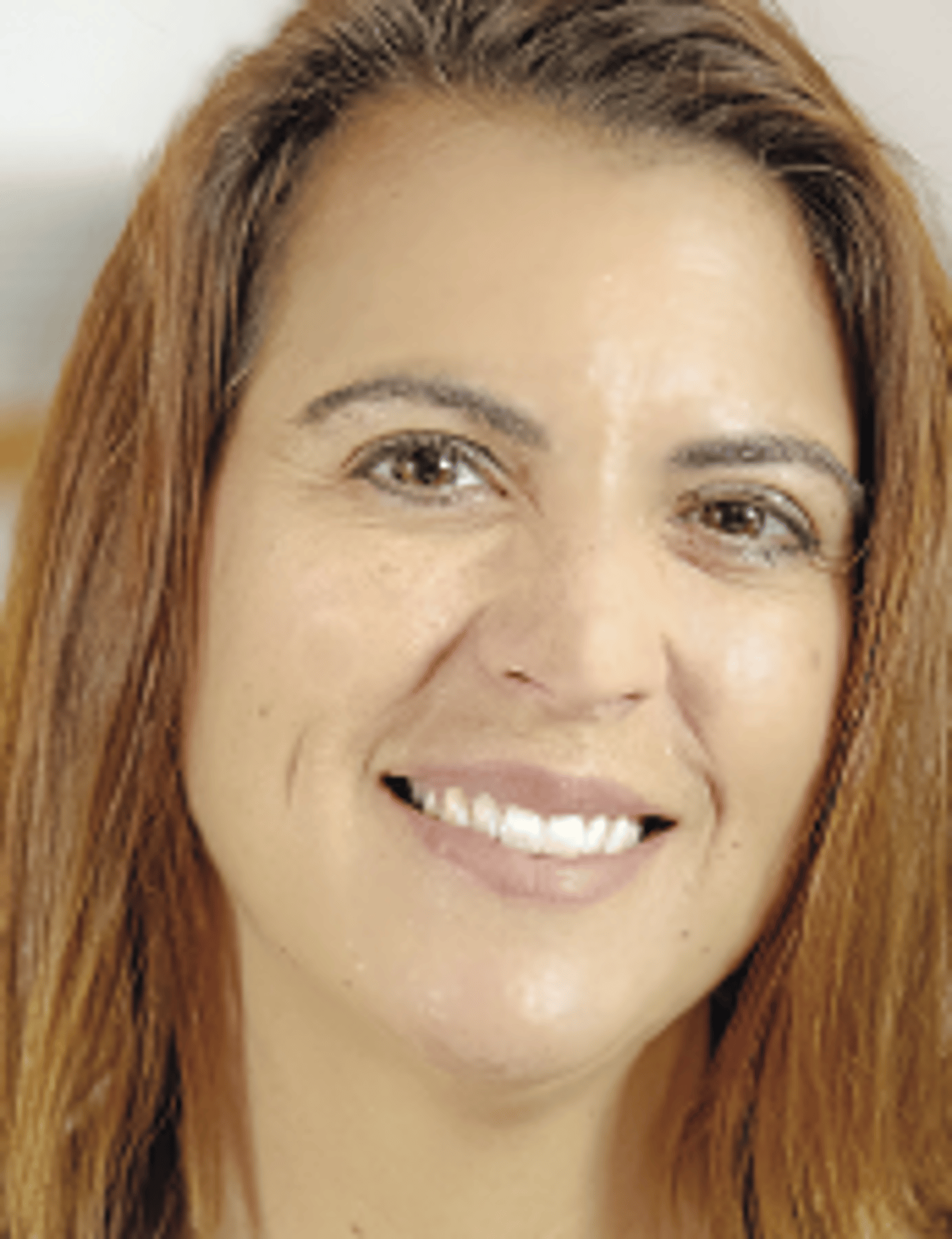 a close up of a woman who is smiling at the camera