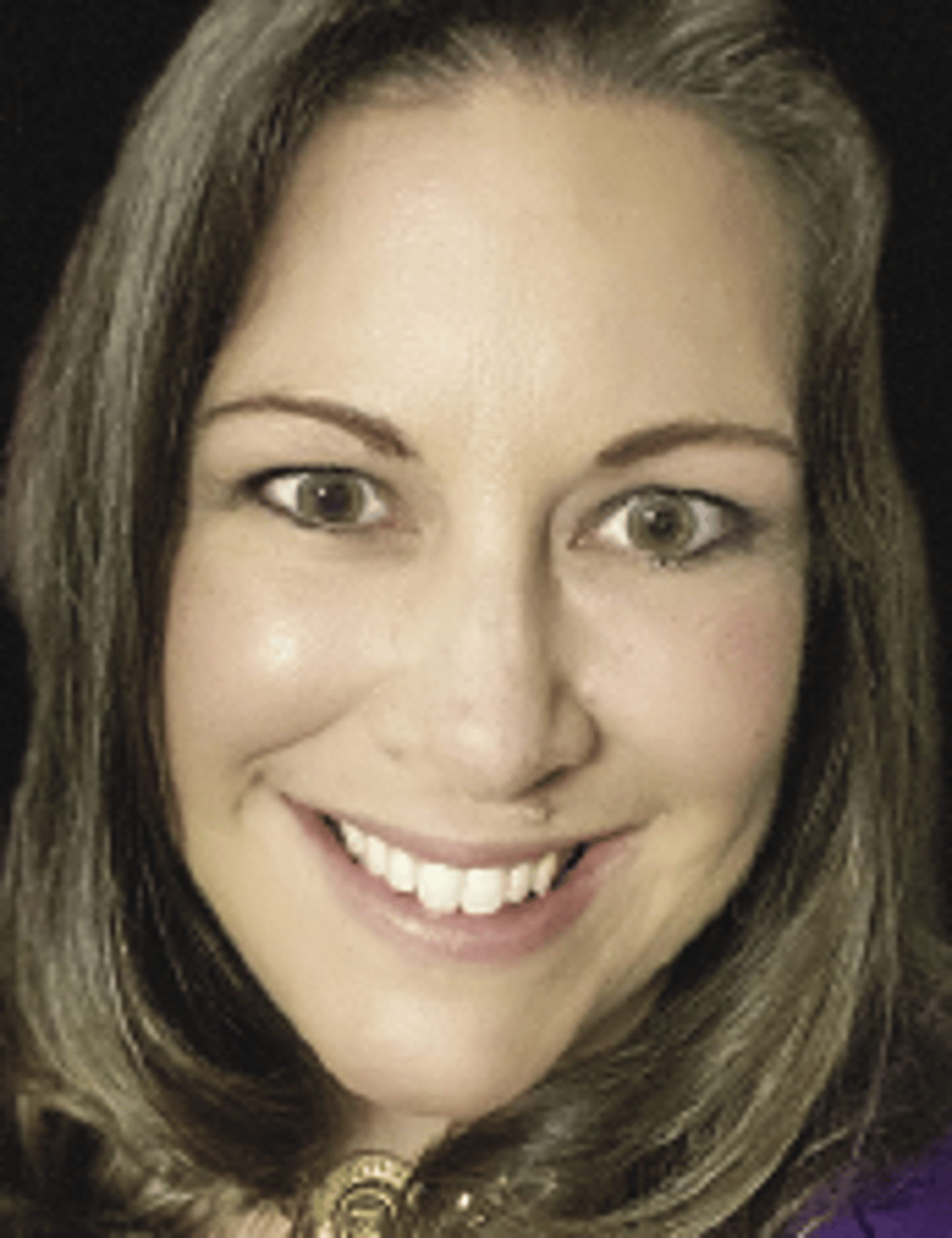 a close up of a woman who is smiling at the camera