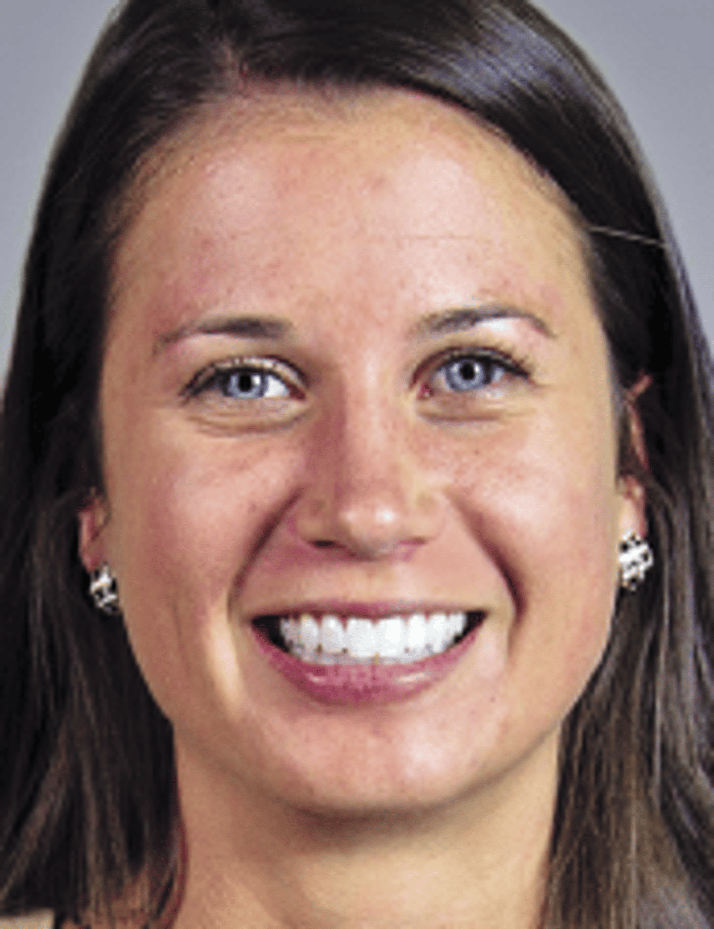 a close up of a woman who is smiling at the camera