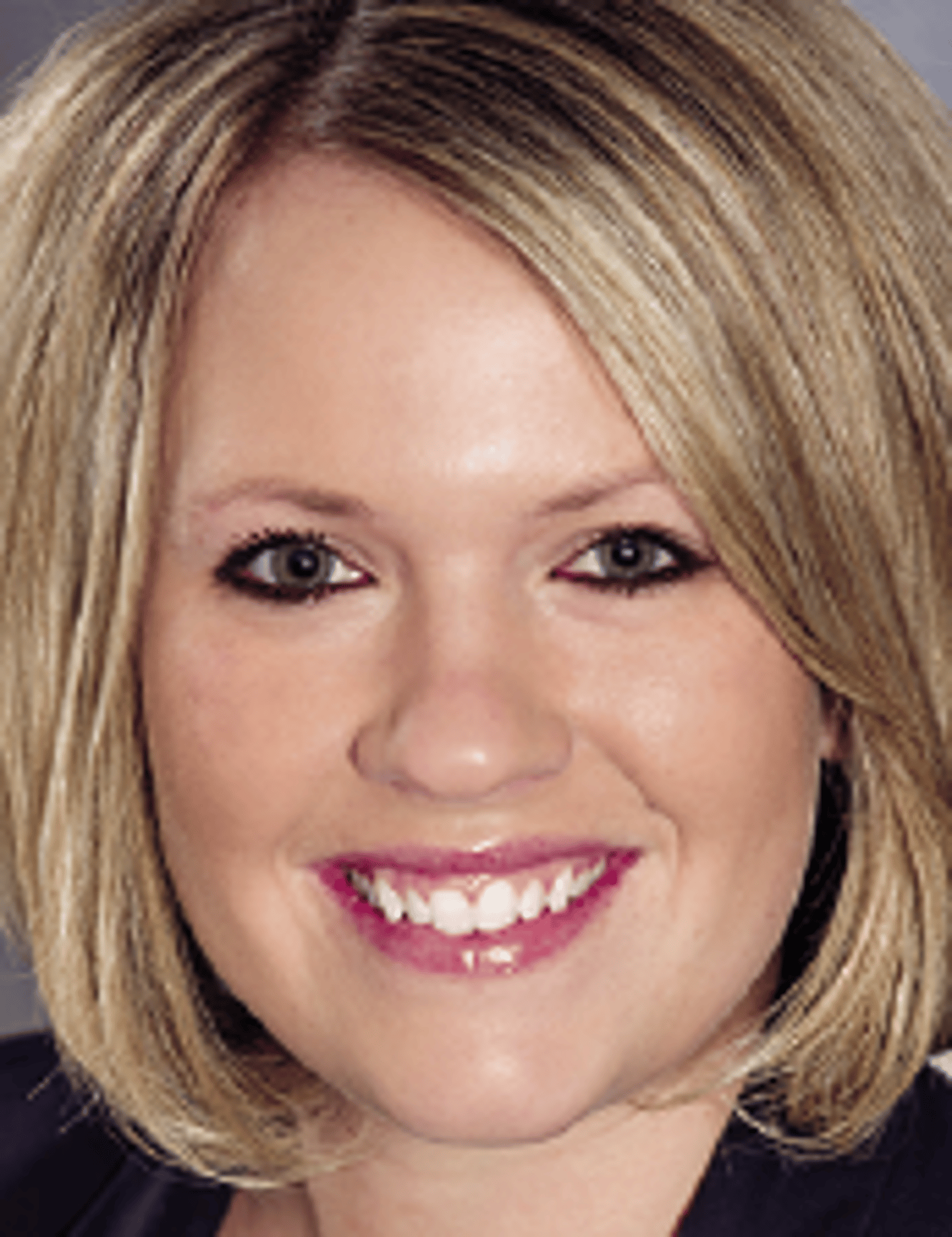 a close up of a woman who is smiling and looking at the camera