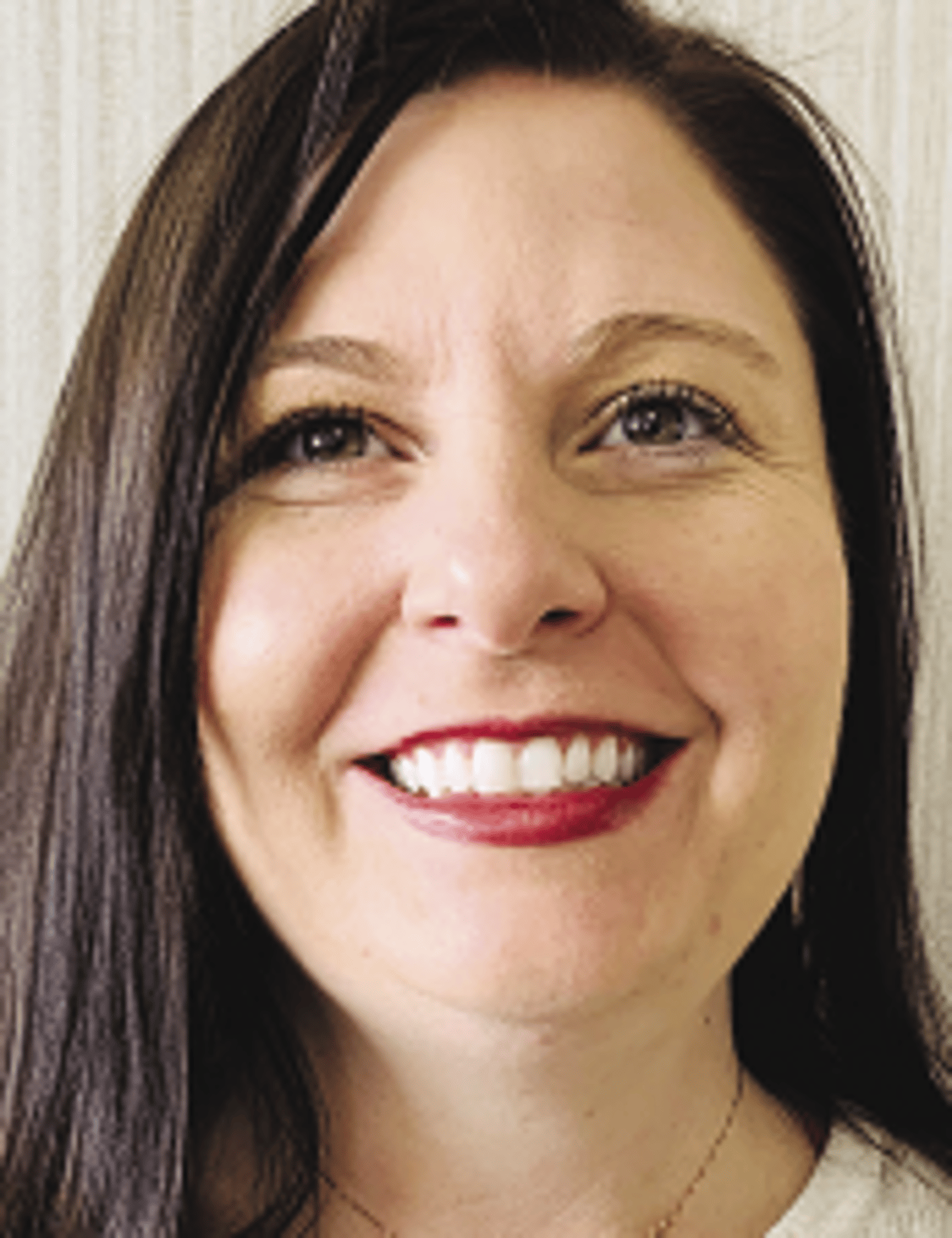 a close up of a woman who is smiling at the camera