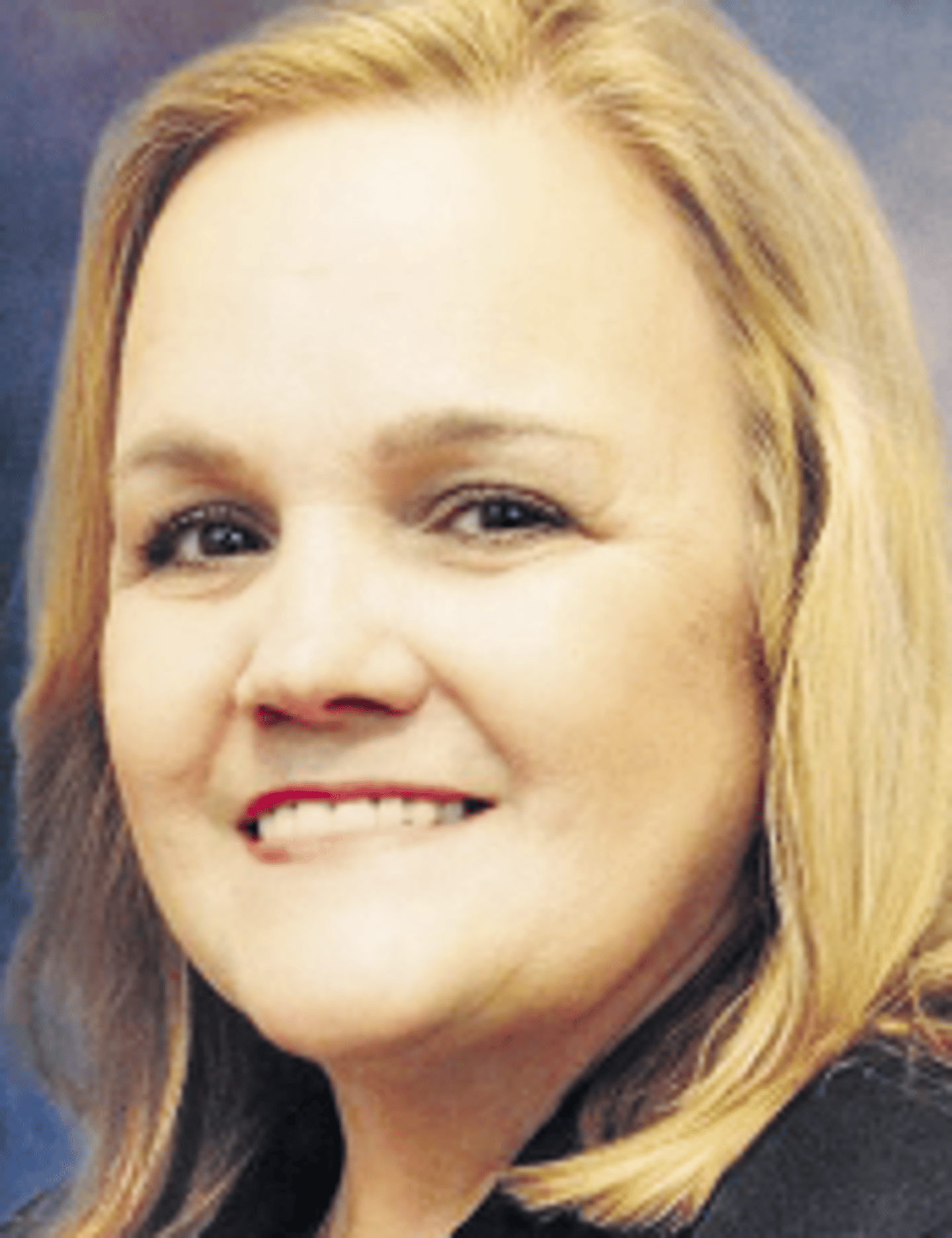 a close up of a woman who is smiling at the camera