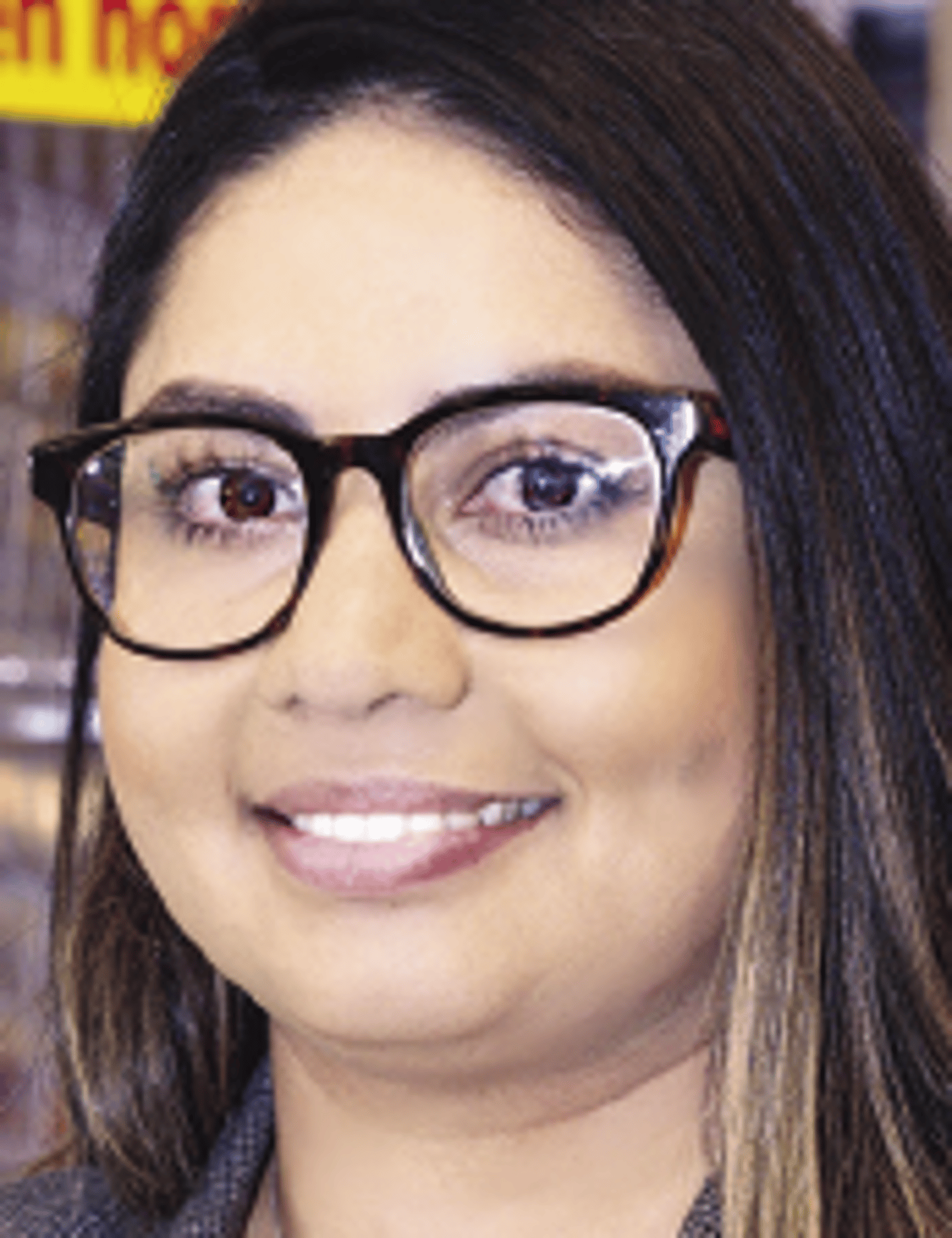 a close up of a person in glasses looking at the camera