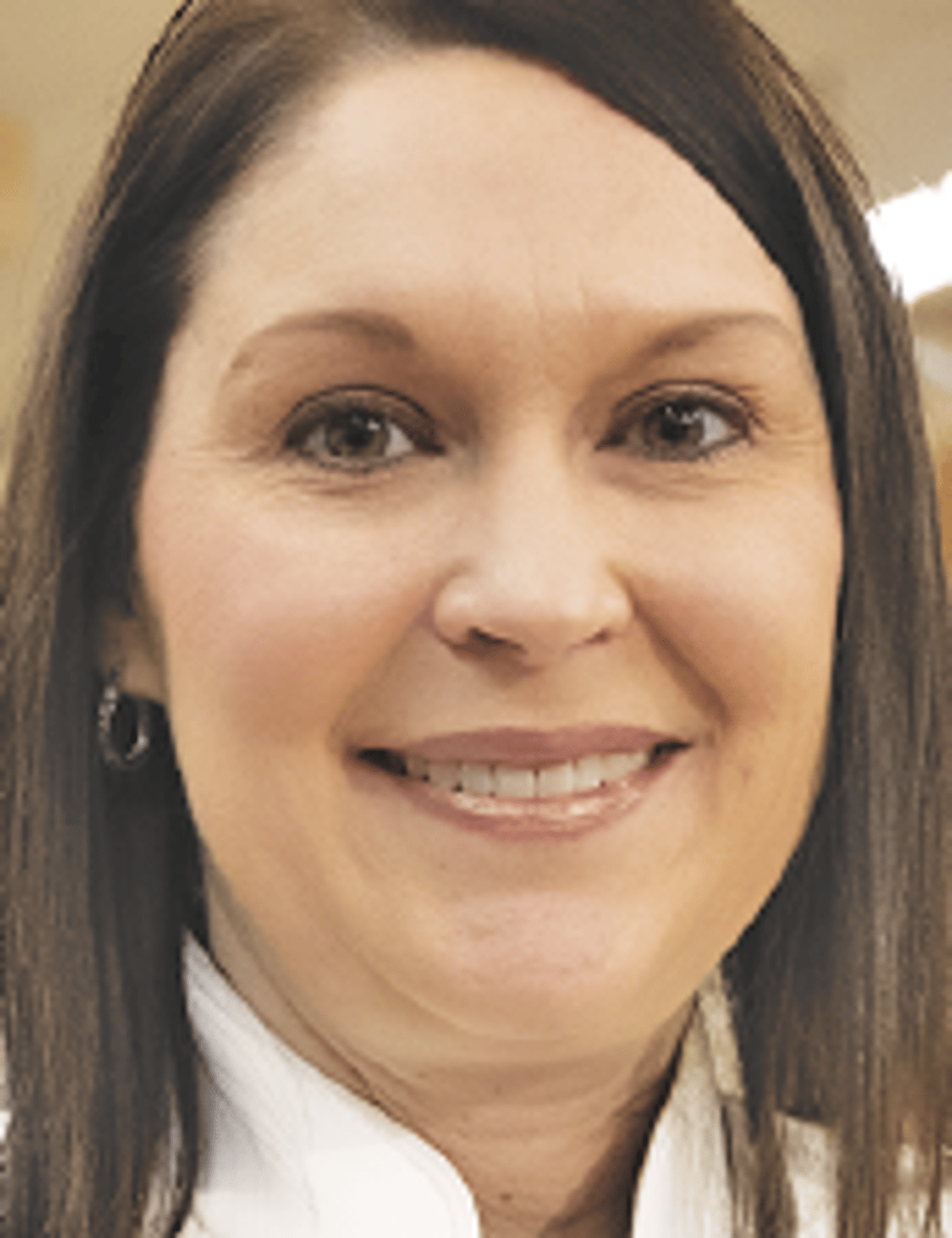 a close up of a woman smiling for the camera