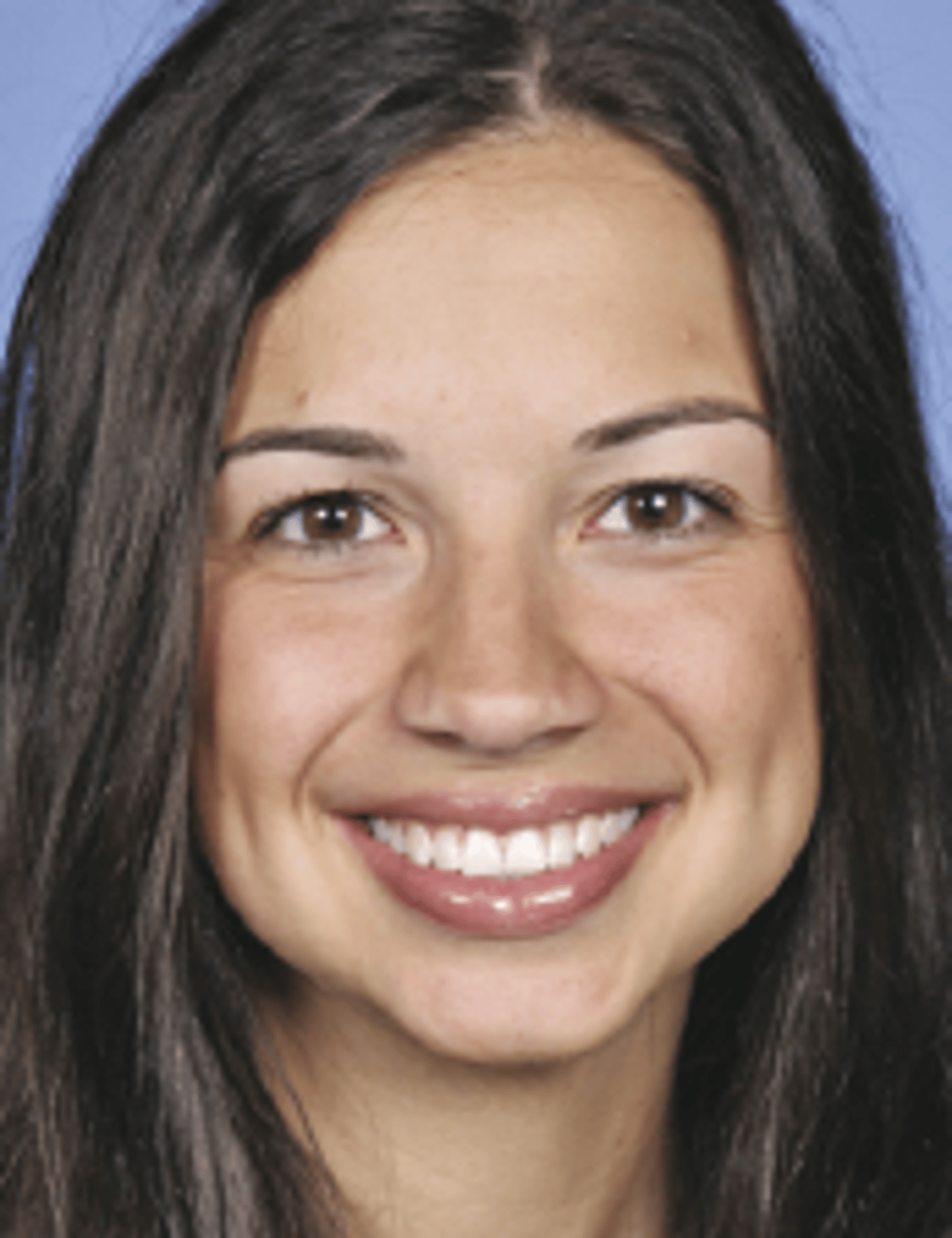 a close up of a woman who is smiling and looking at the camera