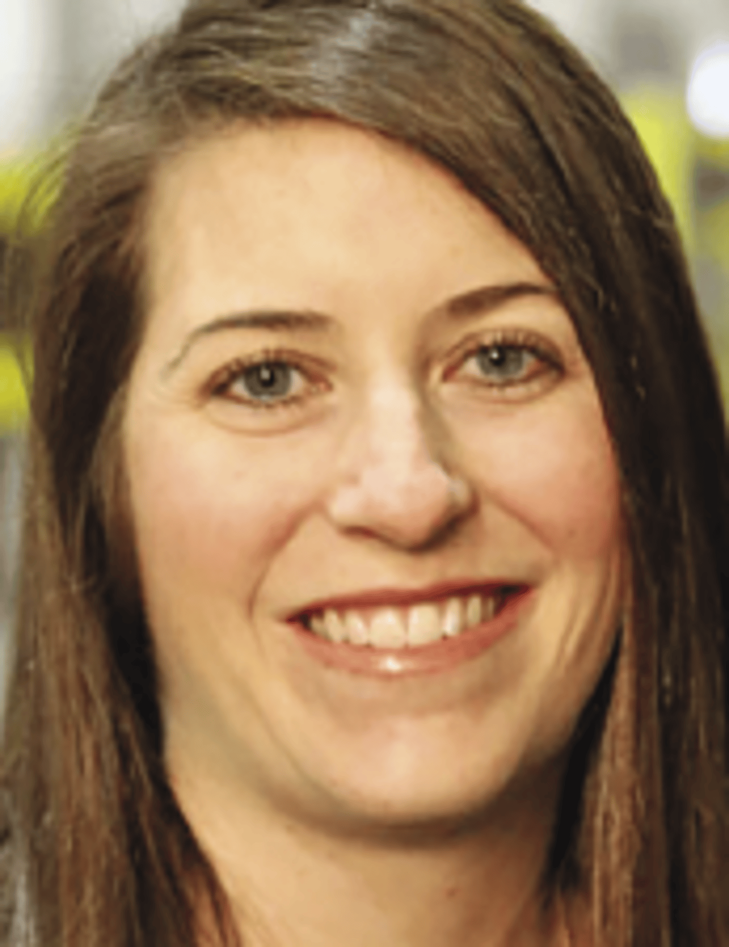 a close up of a woman who is smiling and looking at the camera