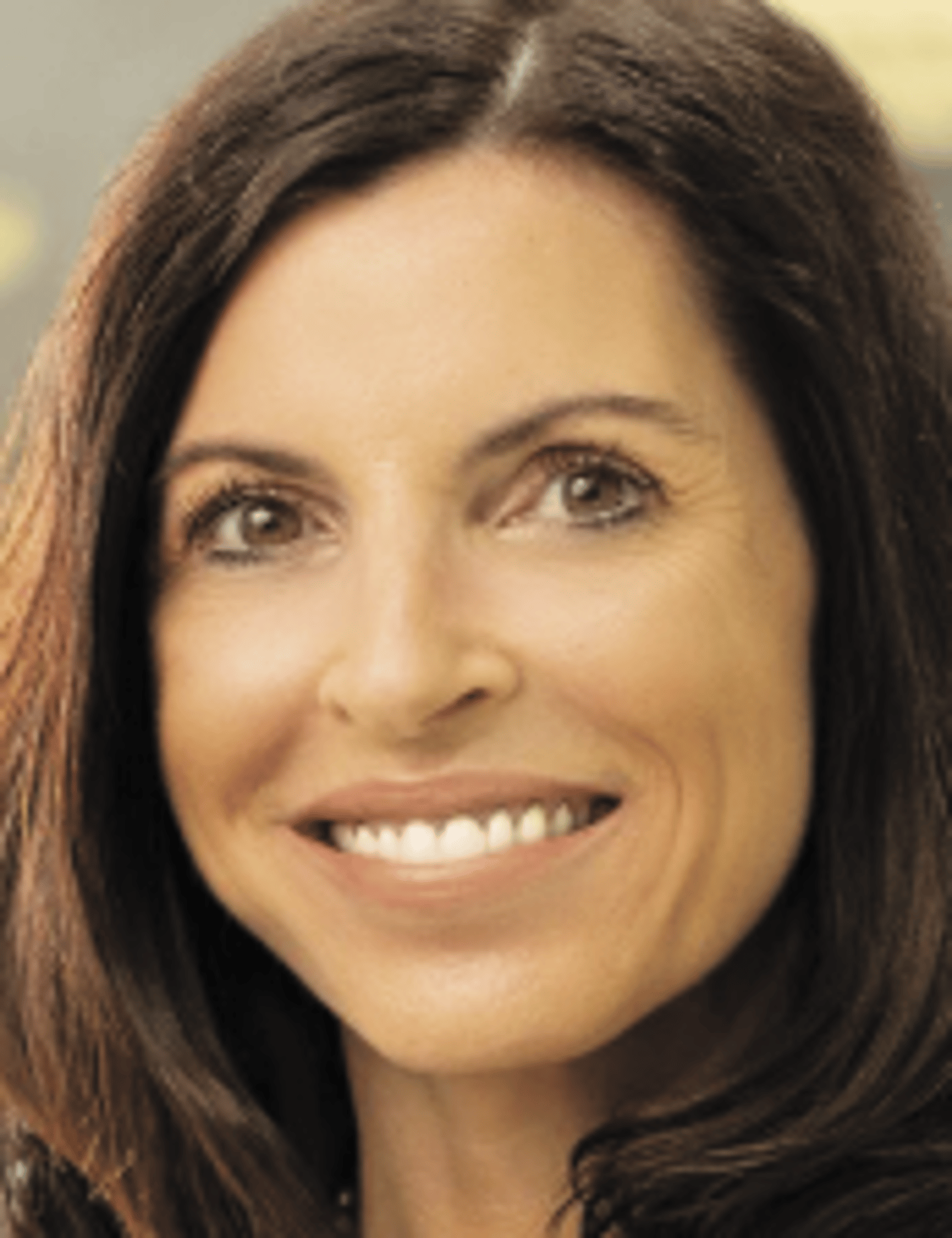 a close up of a woman who is smiling at the camera